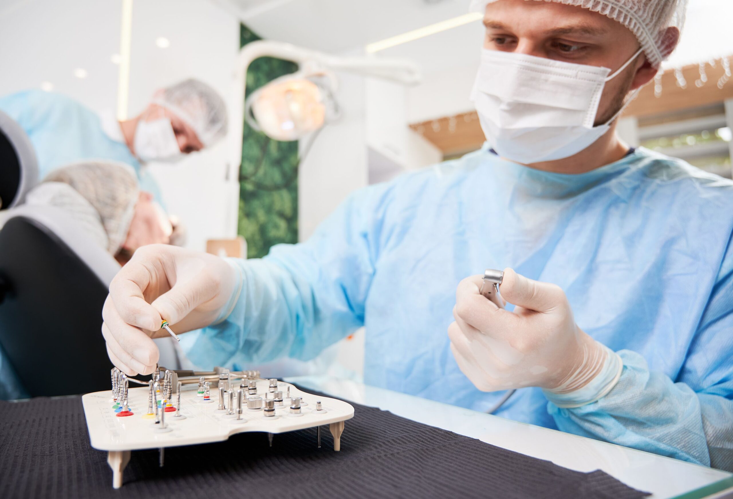 bigstock-Dentist-Choosing-Dental-Implan-428566598