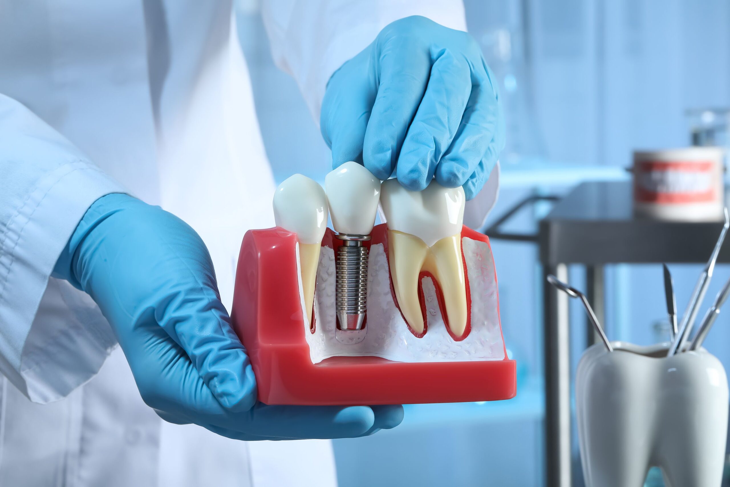 bigstock-Dentist-Holding-Educational-Mo-444947231